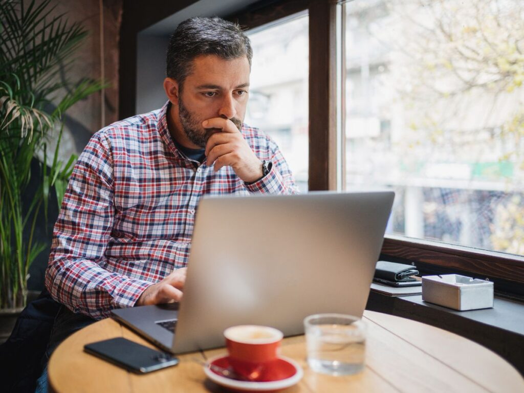 Person checking payment status on a laptop