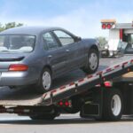 Tow truck lifting a parked car