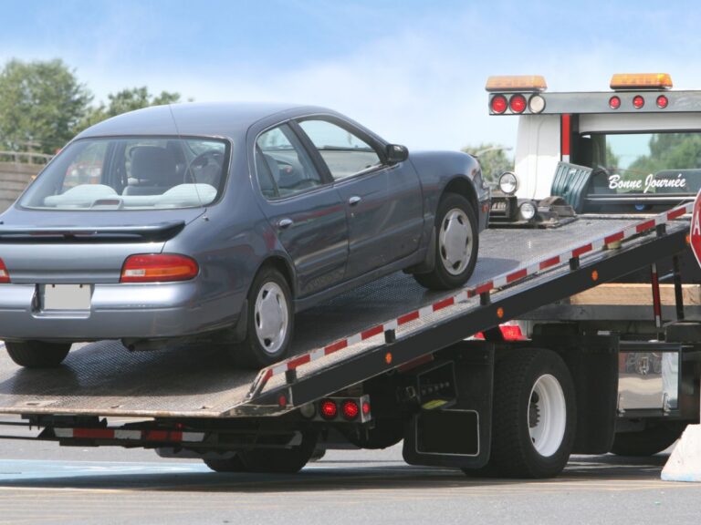 Tow truck lifting a parked car